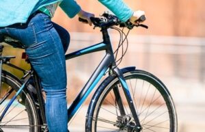 woman in blue jeans riding bike