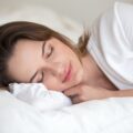 Woman lying in bed sleeping peacefully