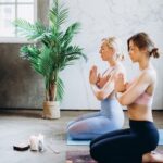 2 women kneeling in meditation session