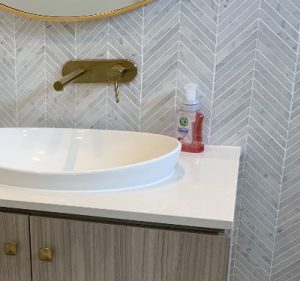 Bathroom vanity and herringbone tiles